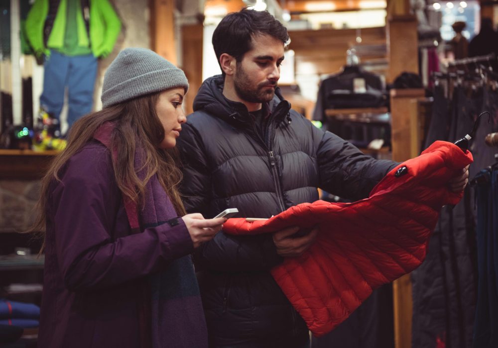 Couple selecting apparel together in a clothes shop